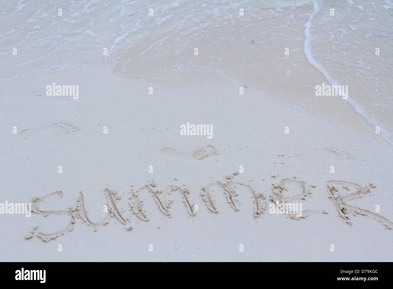 Summer written on the beach with wave Stock Photo - Alamy