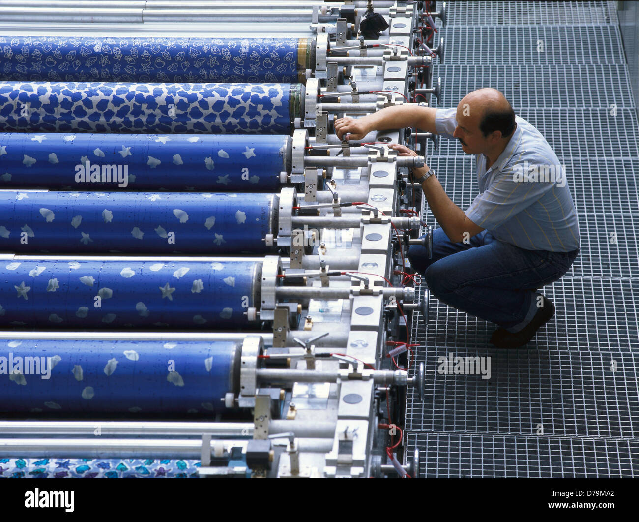 Mechanic adjusting printing machine Stock Photo