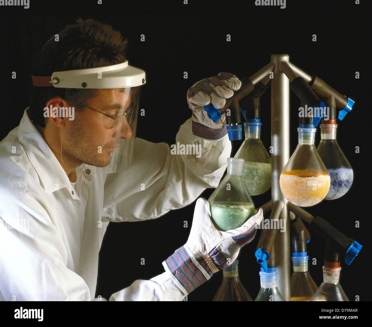 Researcher handling flasks containing freeze-dried active substances found in mushrooms bacteria Stock Photo