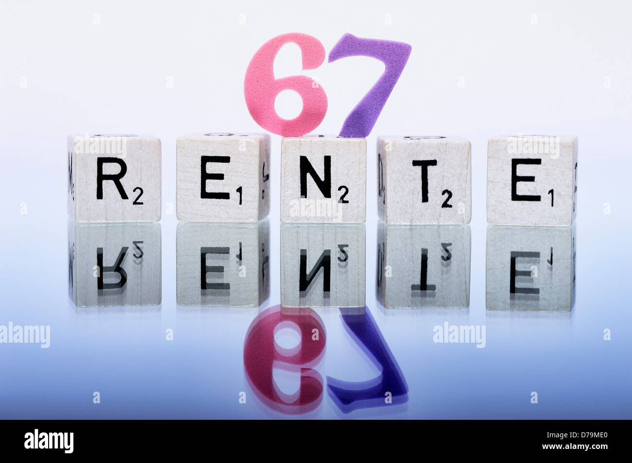 Cube letters with the word Pension, Pension beginning at the age of 67 years , Würfelbuchstaben mit dem Wort Rente, Rentenbeginn Stock Photo