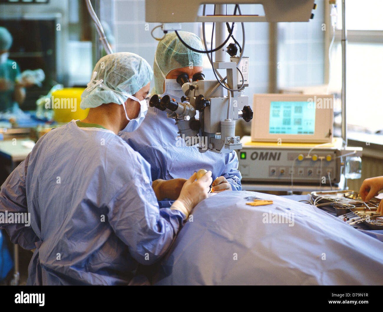 Doctors performing microsurgery during eye operation Stock Photo