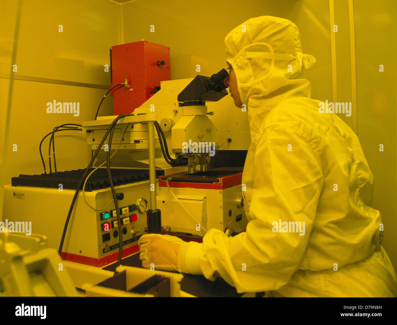 Quality assurance technician analyzing samples through microscope Stock ...
