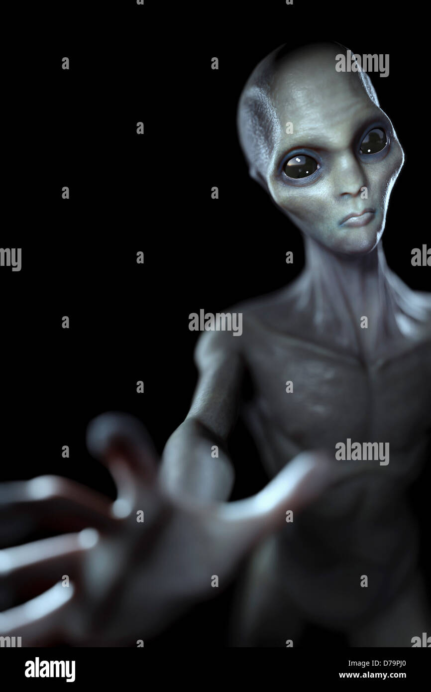 Grey alien extraterrestrial in dark black room, looking at viewer