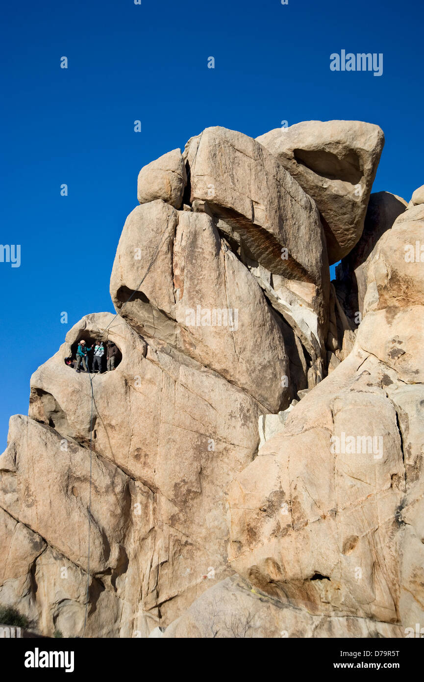 Rock climbers in cave at Joshua Tree National Monument in California Stock Photo