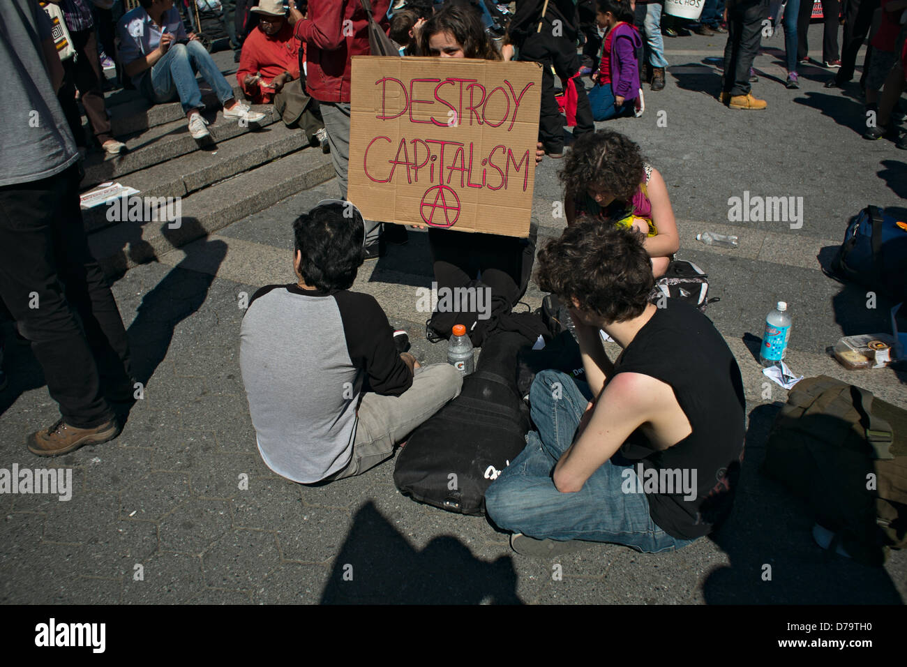 Wednesday, May 1, 2013, New York, NY, US: A woman holds a sign reading 'Destroy capitalism' as protesters gather in New York's Union Square to mark  International Workers' Day, also known as May Day. Stock Photo