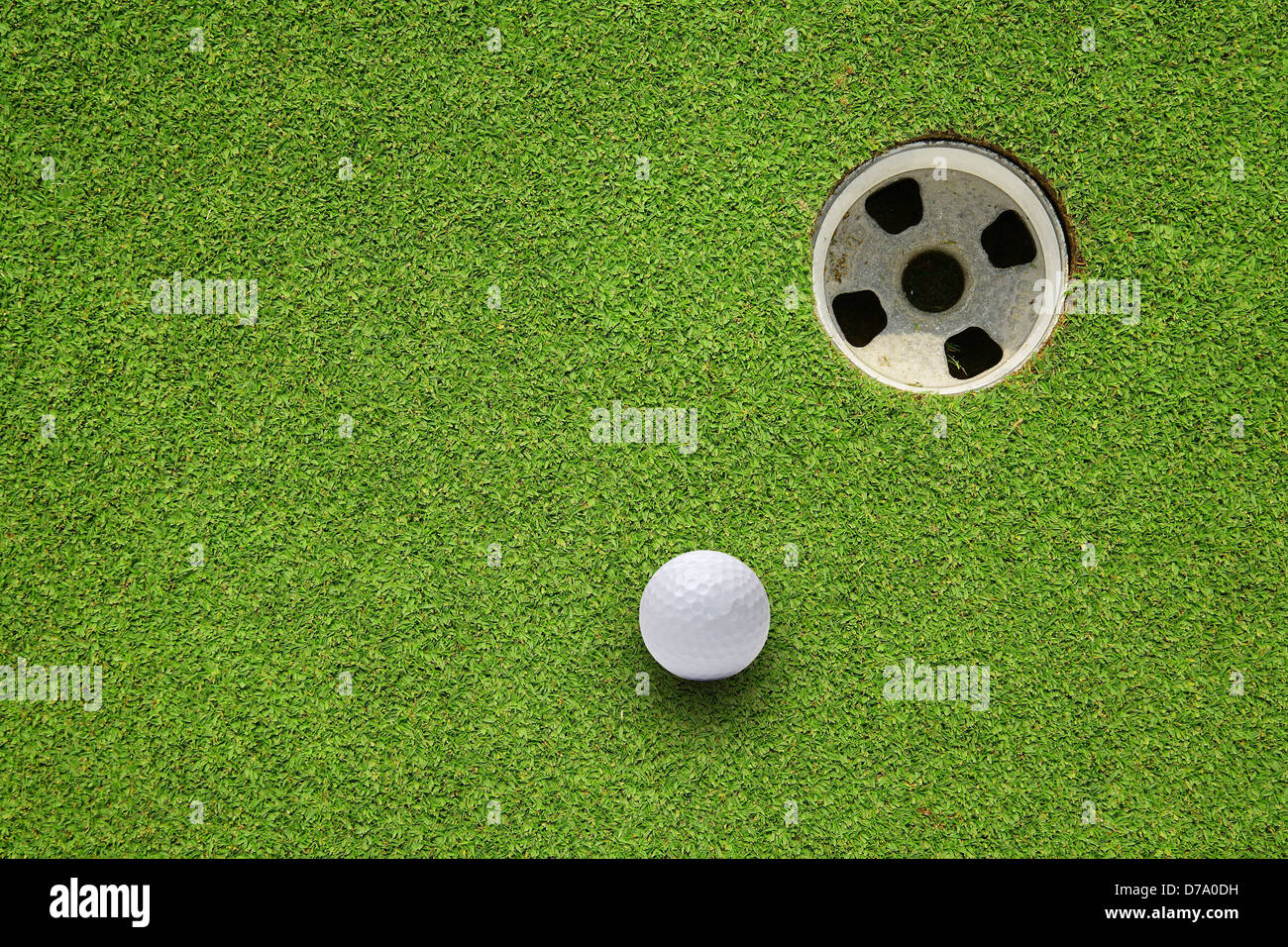 Golf ball very close to the hole Stock Photo