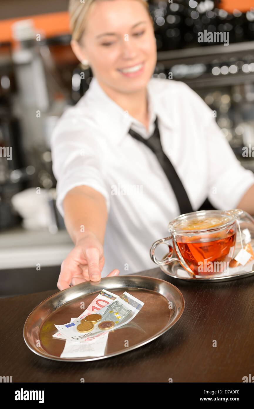 Attractive waitress taking tip in bar from tray euro Stock Photo Alamy