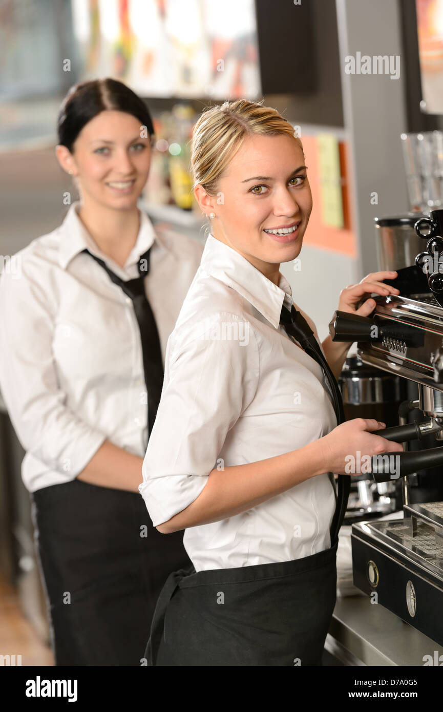 Smiling young waitresses serving coffee in restaurant Stock Photo Alamy