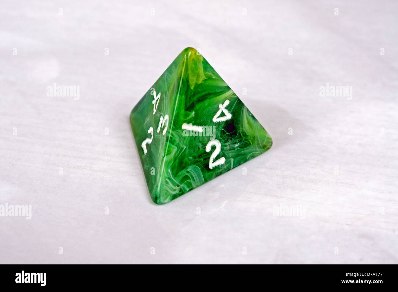 Platonic 4 sided pyramic die against a white background. Stock Photo