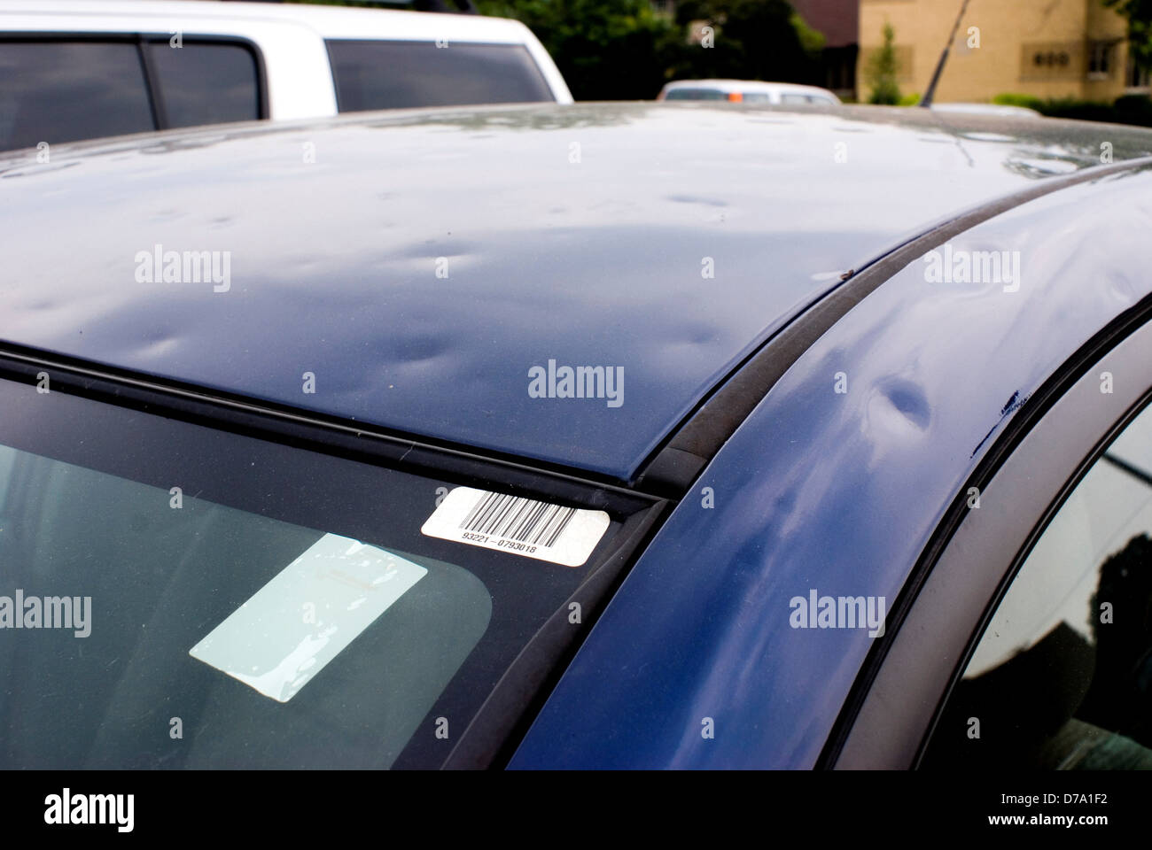 Hailstone damage on car roof Stock Photo