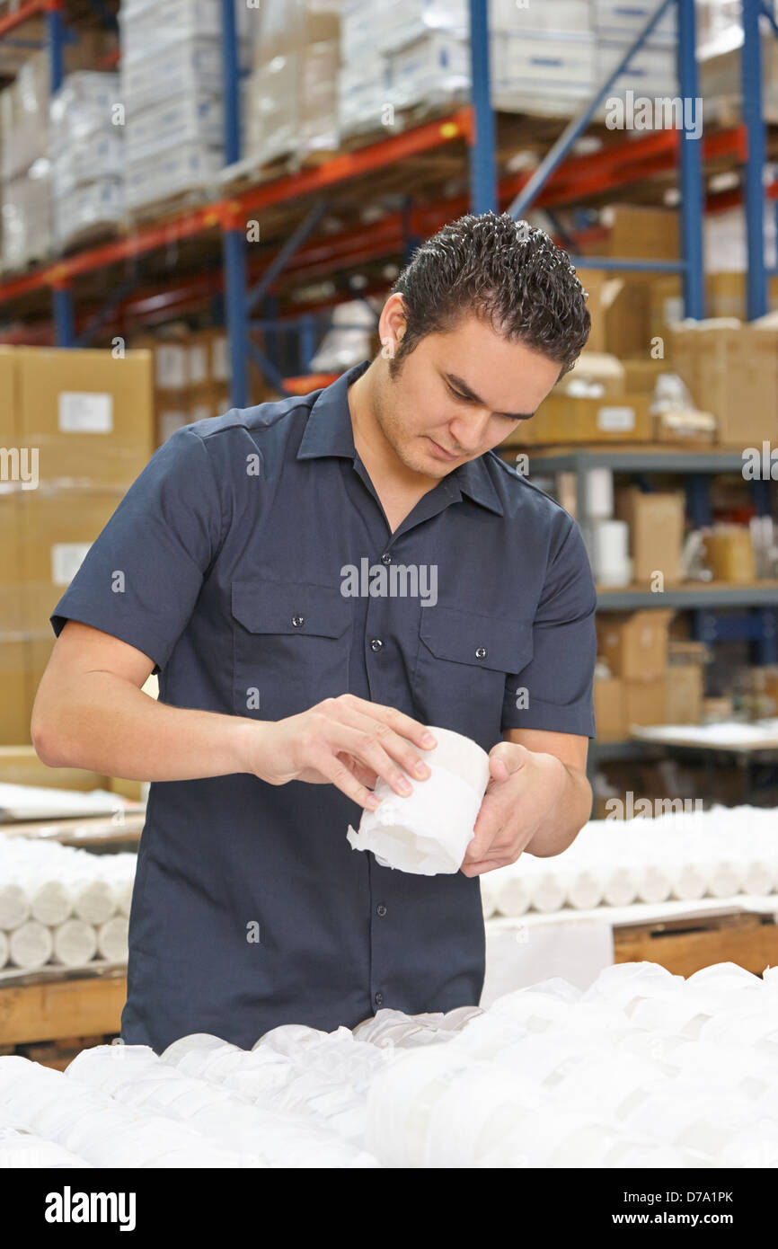 Factory Worker Checking Goods On Production Line Stock Photo