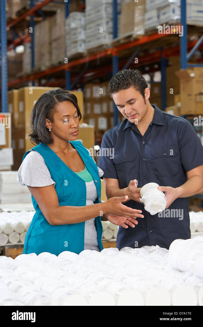 Factory Worker Training Colleague On Production Line Stock Photo