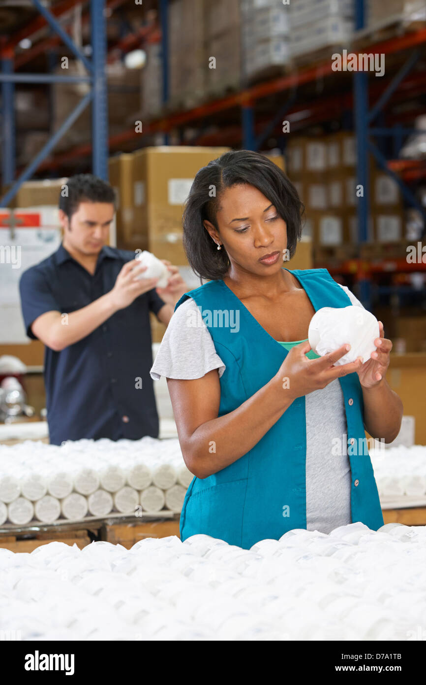 Factory Worker Checking Goods On Production Line Stock Photo