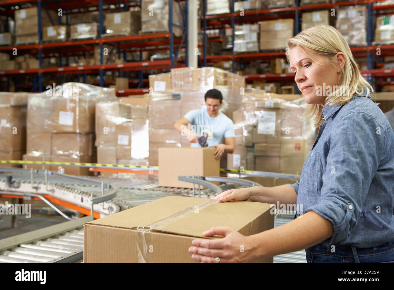 Workers In Distribution Warehouse Stock Photo