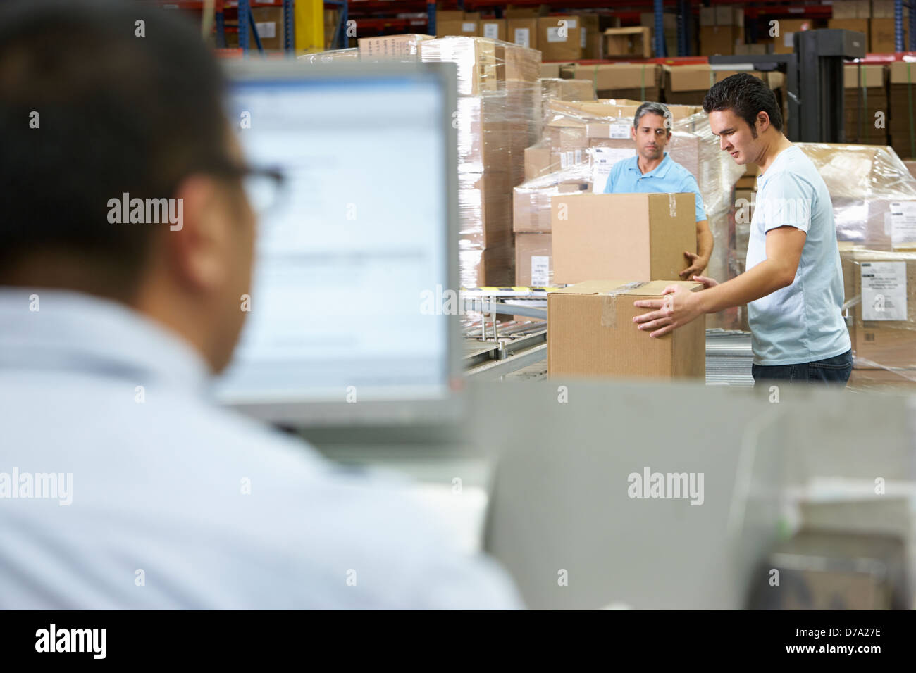 Person At Computer Terminal In Distribution Warehouse Stock Photo