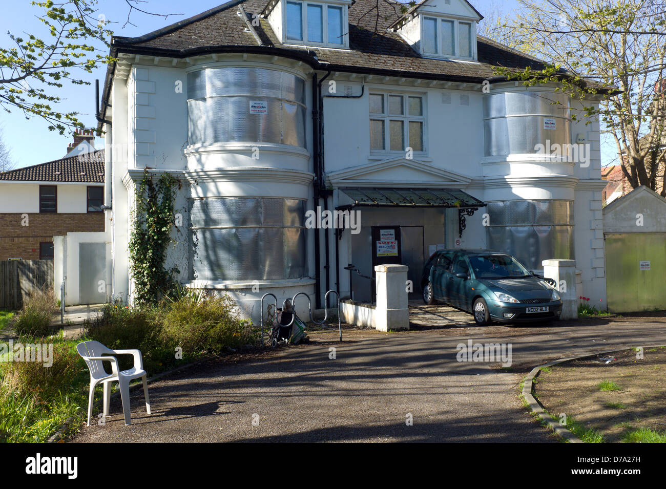 Large detached abandoned and boarded up house, Hove, UK Stock Photo
