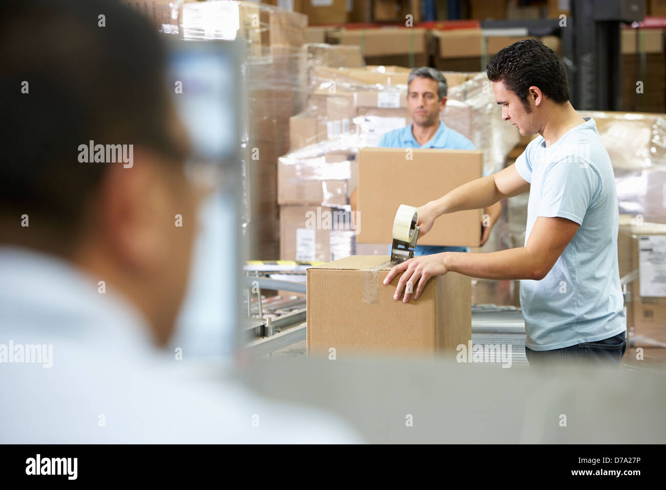 Person At Computer Terminal In Distribution Warehouse Stock Photo