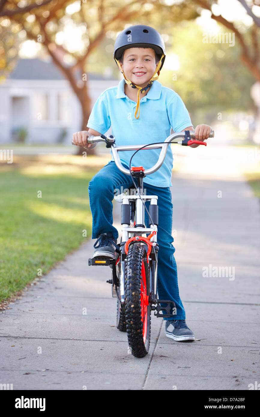 Boy Wearing Safety Helmet Riding Bike Stock Photo Alamy