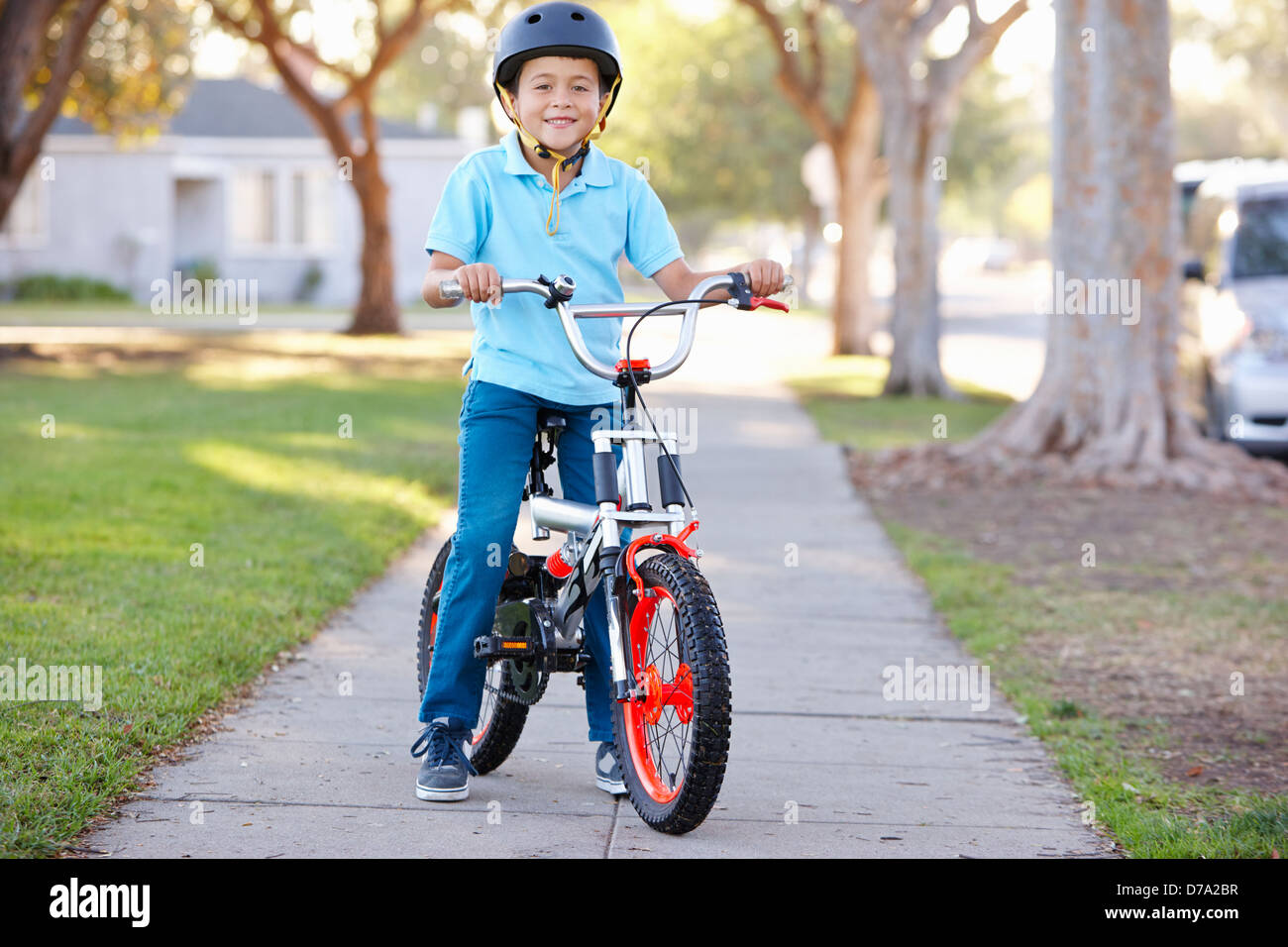 Boy Wearing Safety Helmet Riding Bike Stock Photo Alamy