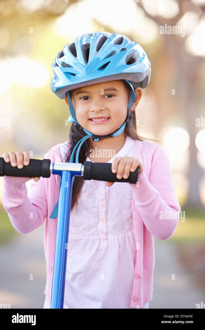 Girl wearing helmet riding scooter hires stock photography and images