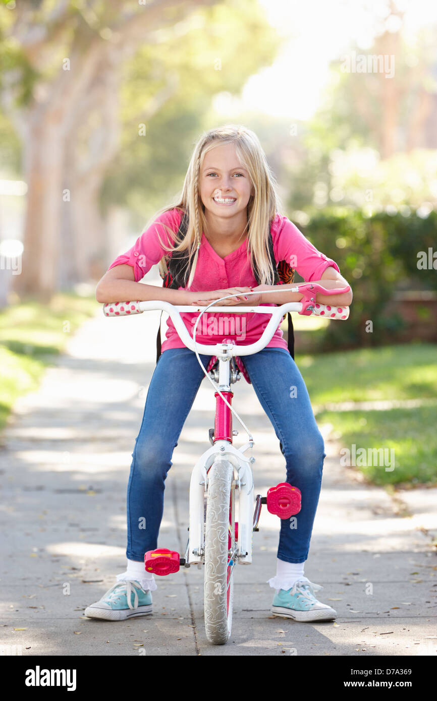 Girl Wearing Rucksack Cycling To School Stock Photo
