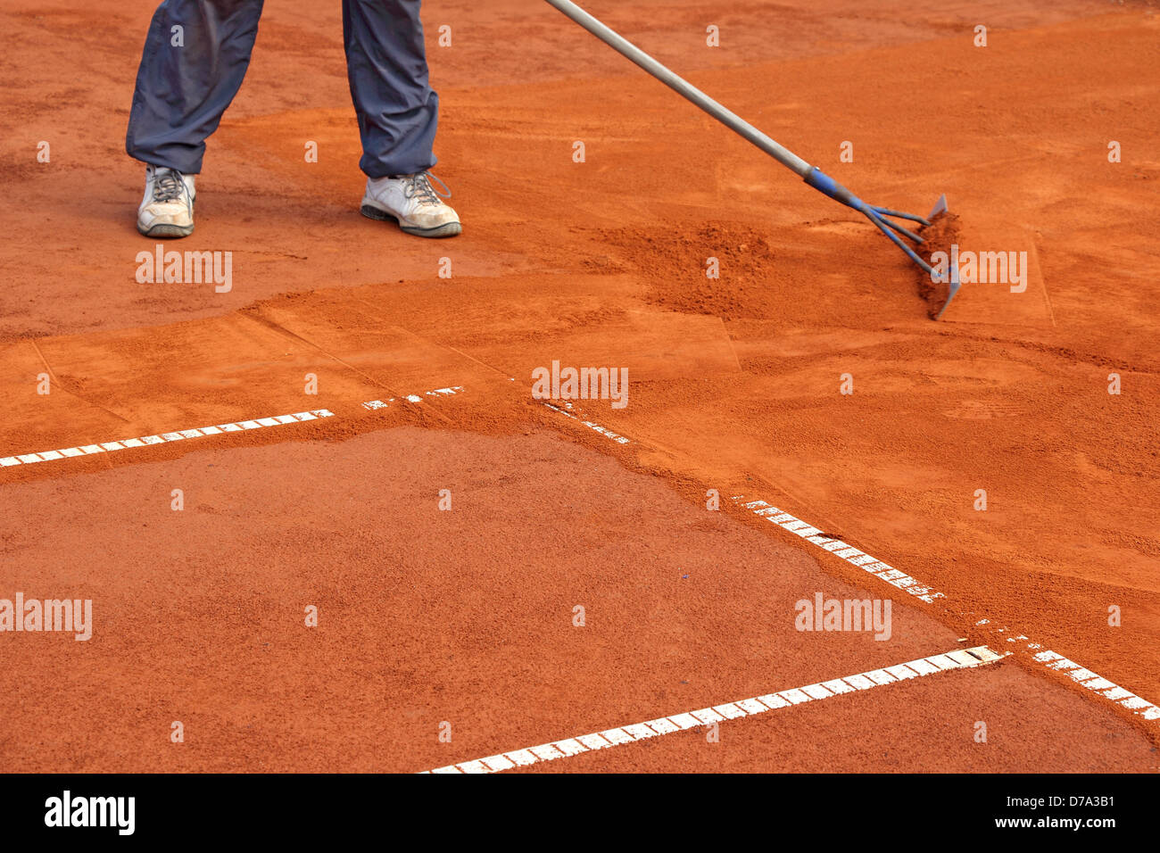 A worker repair the lines on tennis courts Stock Photo