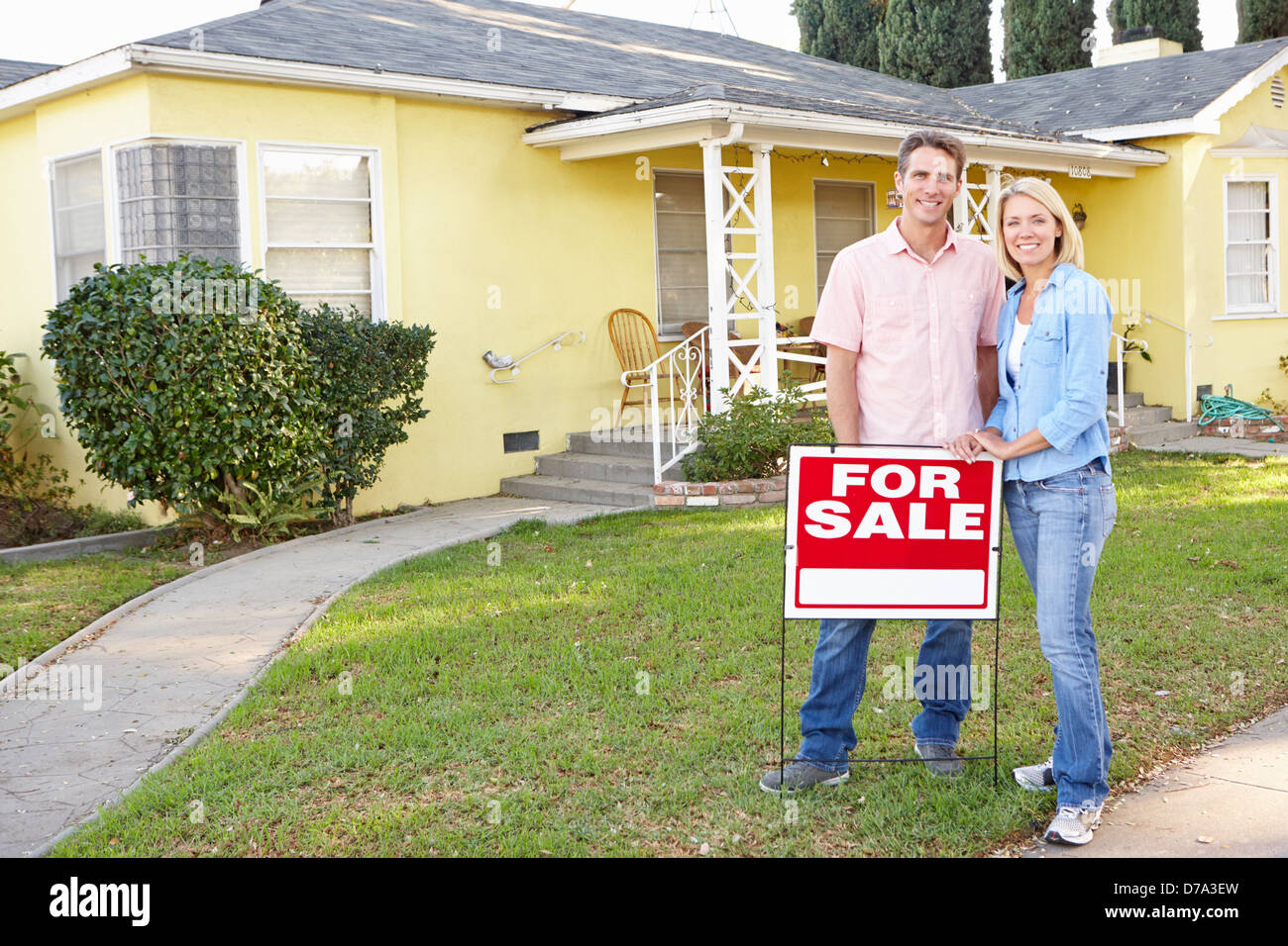 Couple Standing By For Sale Sign Outside Home Stock Photo - Alamy