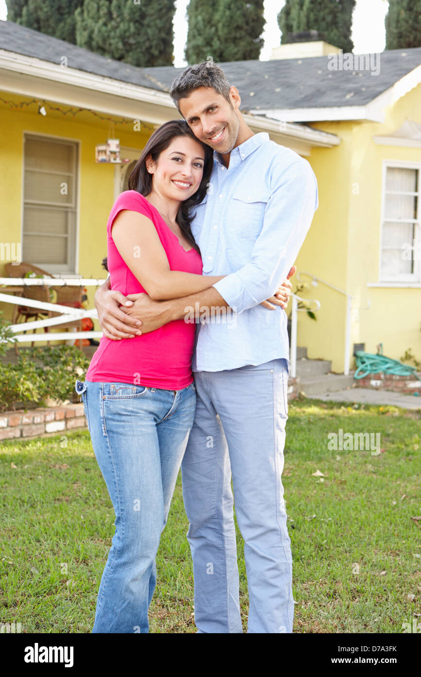 Couple Standing Outside Suburban Home Stock Photo - Alamy