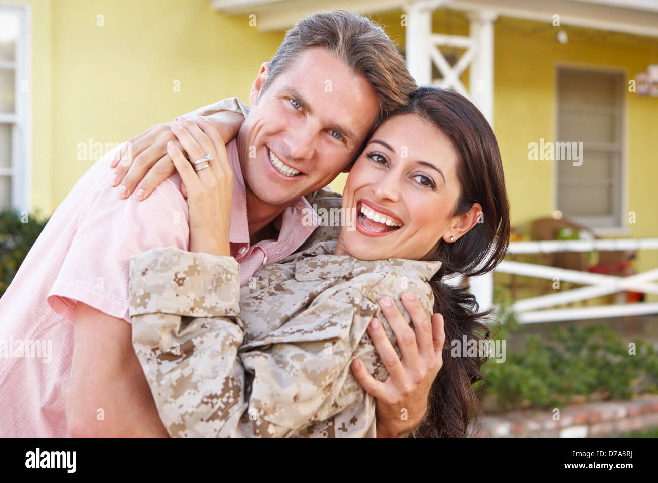 Husband Welcoming Wife Home On Army Leave Stock Photo