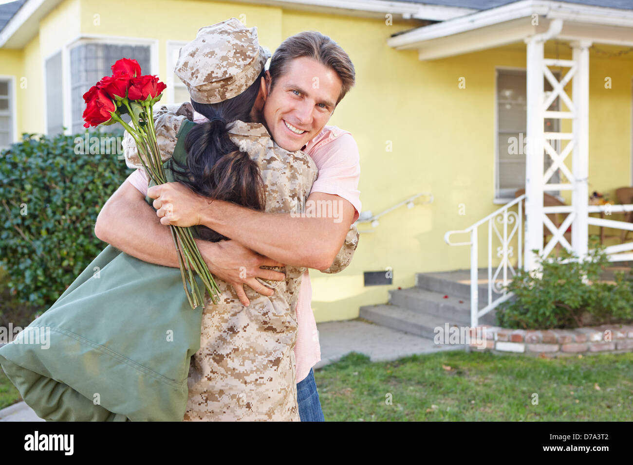 Husband Welcoming Wife Home On Army Leave Stock Photo
