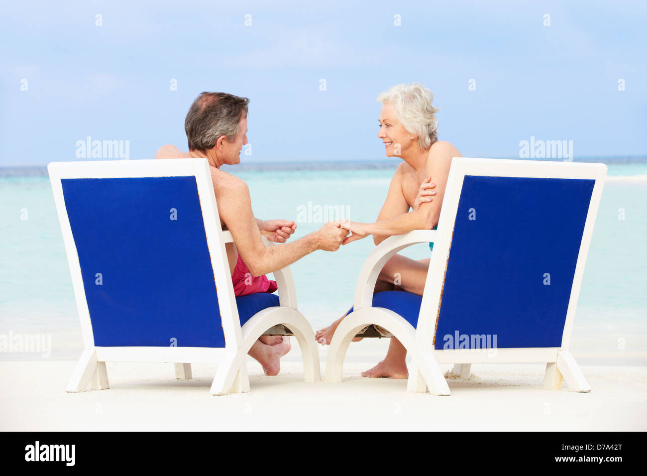 Senior Couple On Beach Relaxing In Chairs Stock Photo - Alamy