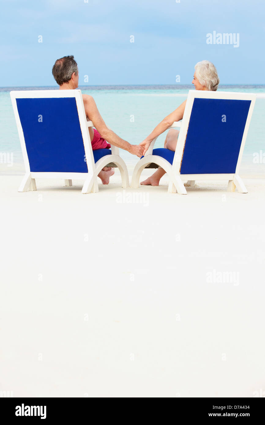 Senior Couple On Beach Relaxing In Chairs Stock Photo - Alamy