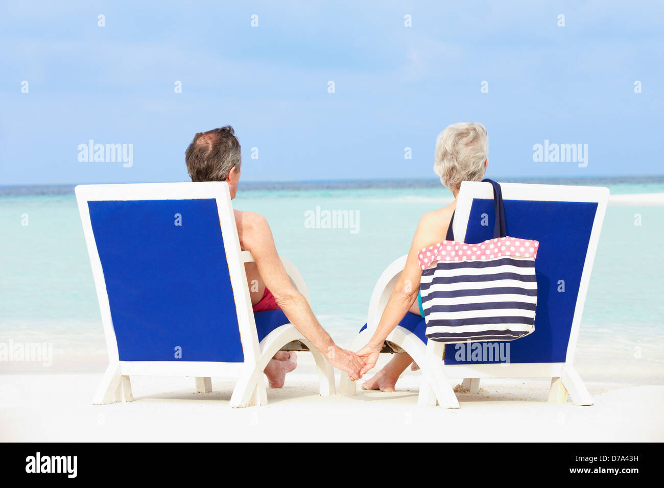 Senior Couple On Beach Relaxing In Chairs Stock Photo - Alamy