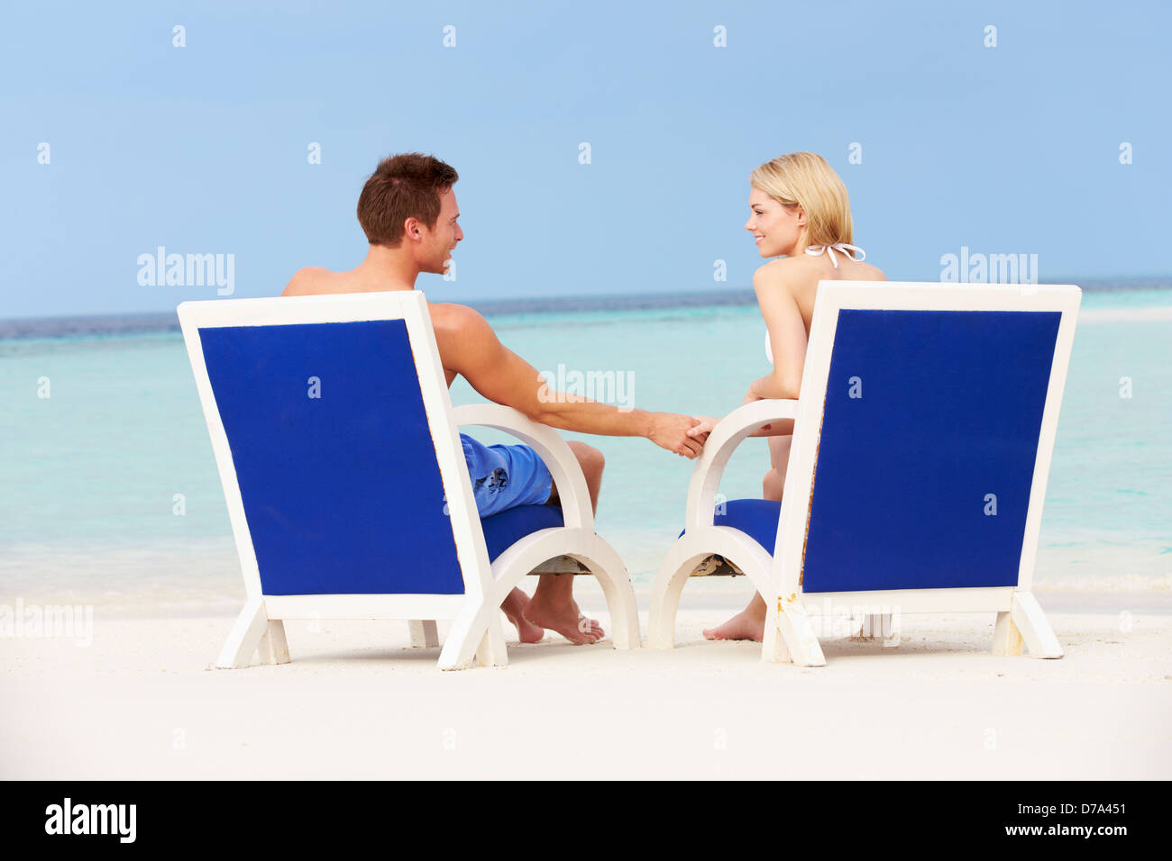 Couple On Beach Relaxing In Chairs Stock Photo - Alamy