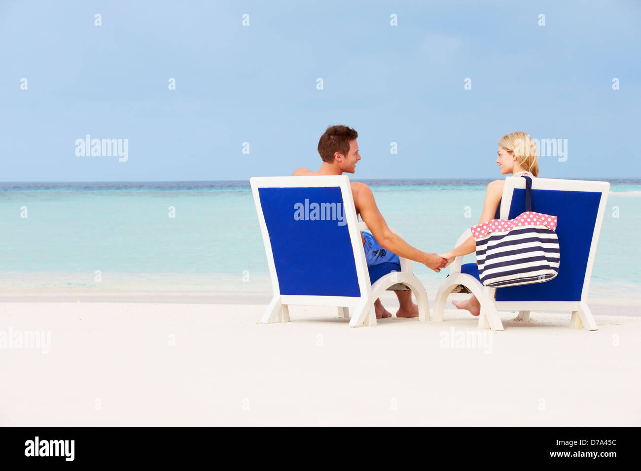 Couple On Beach Relaxing In Chairs Stock Photo - Alamy