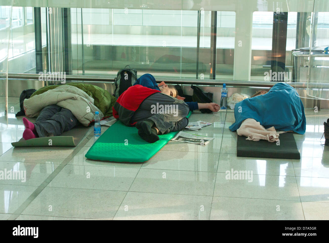Passengers asleep on floor at Dubai airport Stock Photo Alamy