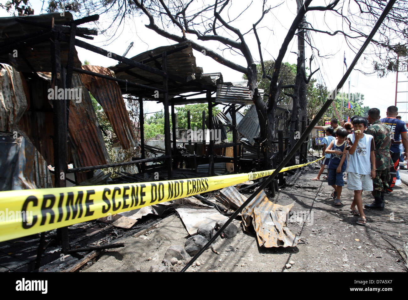 SULTAN KUDARAT, PHILIPPINES, 2nd May, 2013. Filipino fire marshals inspect the razed provincial headquarters of Philippine President Benigno Aquino III’s Liberal Party in the southern Philippine township of Sultan Kudarat town in Maguindanao, May, 2, 2013.  Unidentified men on Wednesday night set afire the building but no casulaty was reported.On May 13, 2013, the Philippines will hold congressional and local elections. Previous elections in the country have been marred by violence, especially in rural areas awash in weapons and private militias. In 2009, 58 people, including 32 media workers, Stock Photo
