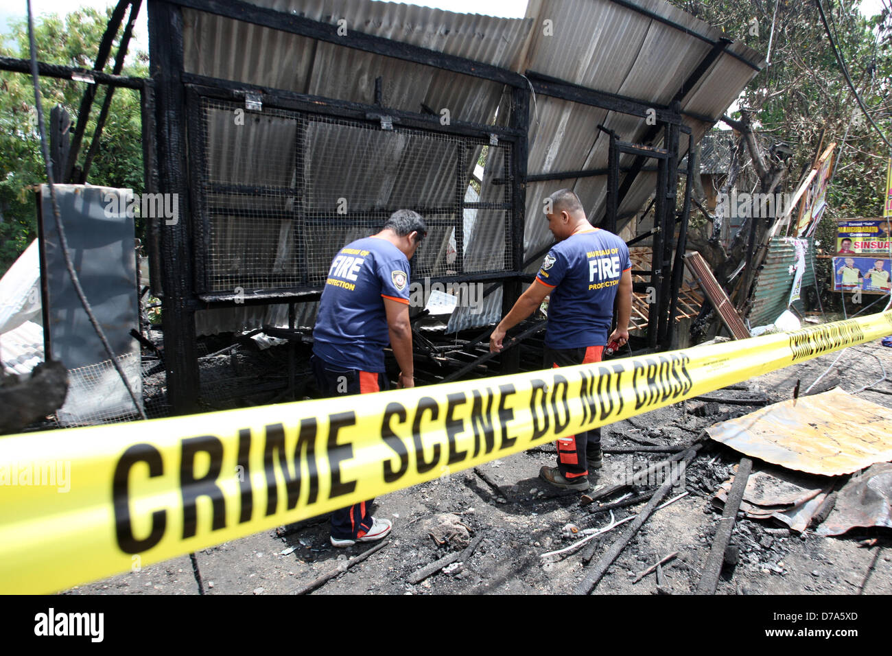 SULTAN KUDARAT, PHILIPPINES, 2nd May, 2013. Filipino fire marshals inspect the razed provincial headquarters of Philippine President Benigno Aquino III’s Liberal Party in the southern Philippine township of Sultan Kudarat town in Maguindanao, May, 2, 2013.  Unidentified men on Wednesday night set afire the building but no casulaty was reported.On May 13, 2013, the Philippines will hold congressional and local elections. Previous elections in the country have been marred by violence, especially in rural areas awash in weapons and private militias. In 2009, 58 people, including 32 media workers, Stock Photo