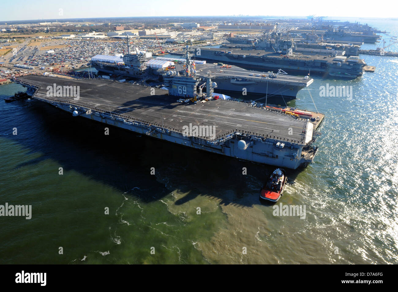 US Navy aircraft carrier USS Dwight D. Eisenhower moves into dock at Naval Station Norfolk after a six-month deployment to the U.S. 5th and 6th Fleet areas of responsibility in support of the Afghan War December 19, 2012 in Norfolk, VA. Stock Photo