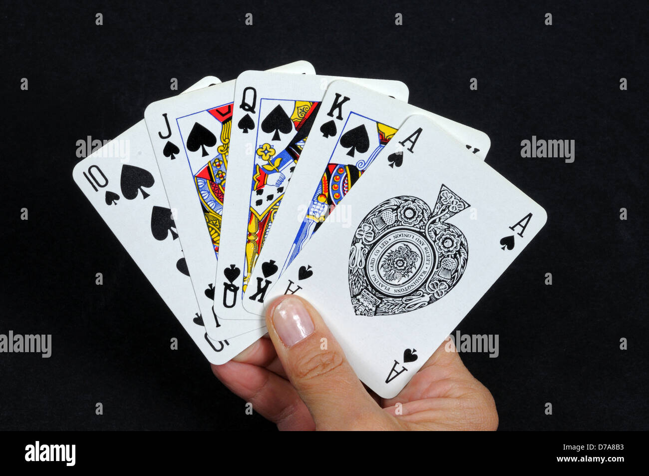 Royal flush poker hand in the spade suit against a black background Stock Photo Alamy