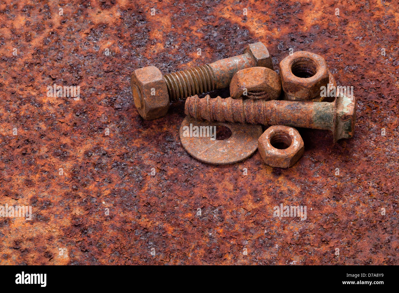 Rusty nuts and bolts on rusty metal surface Stock Photo - Alamy