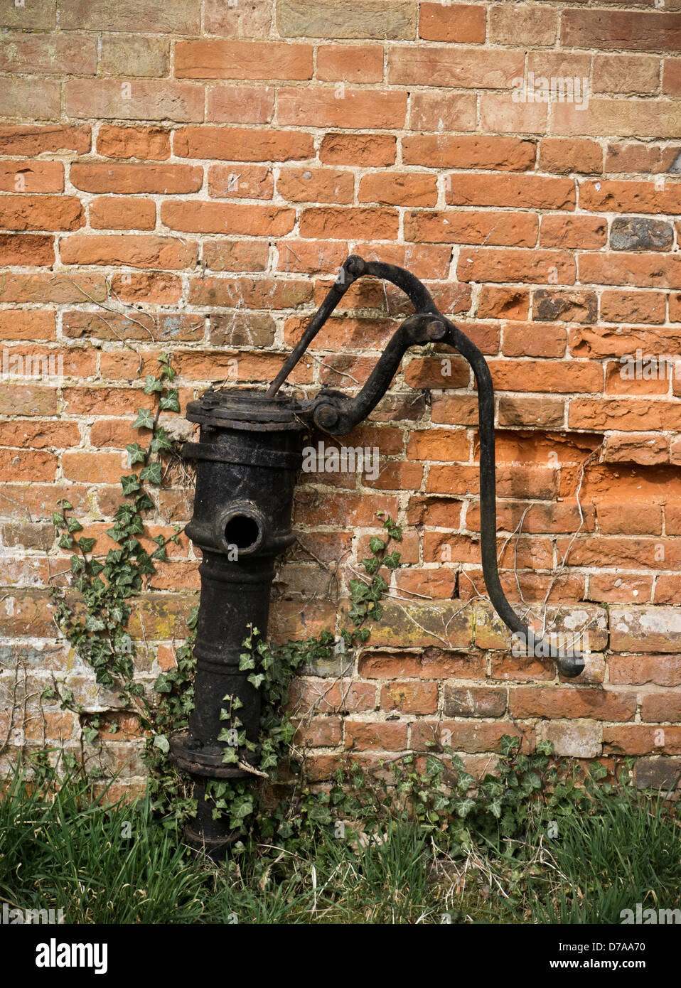 Old water pump against a brick wall Stock Photo Alamy