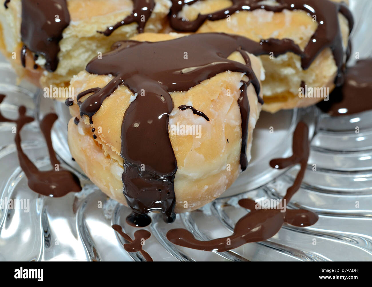 Sweet pastry with sugar and chocolate icing. Stock Photo