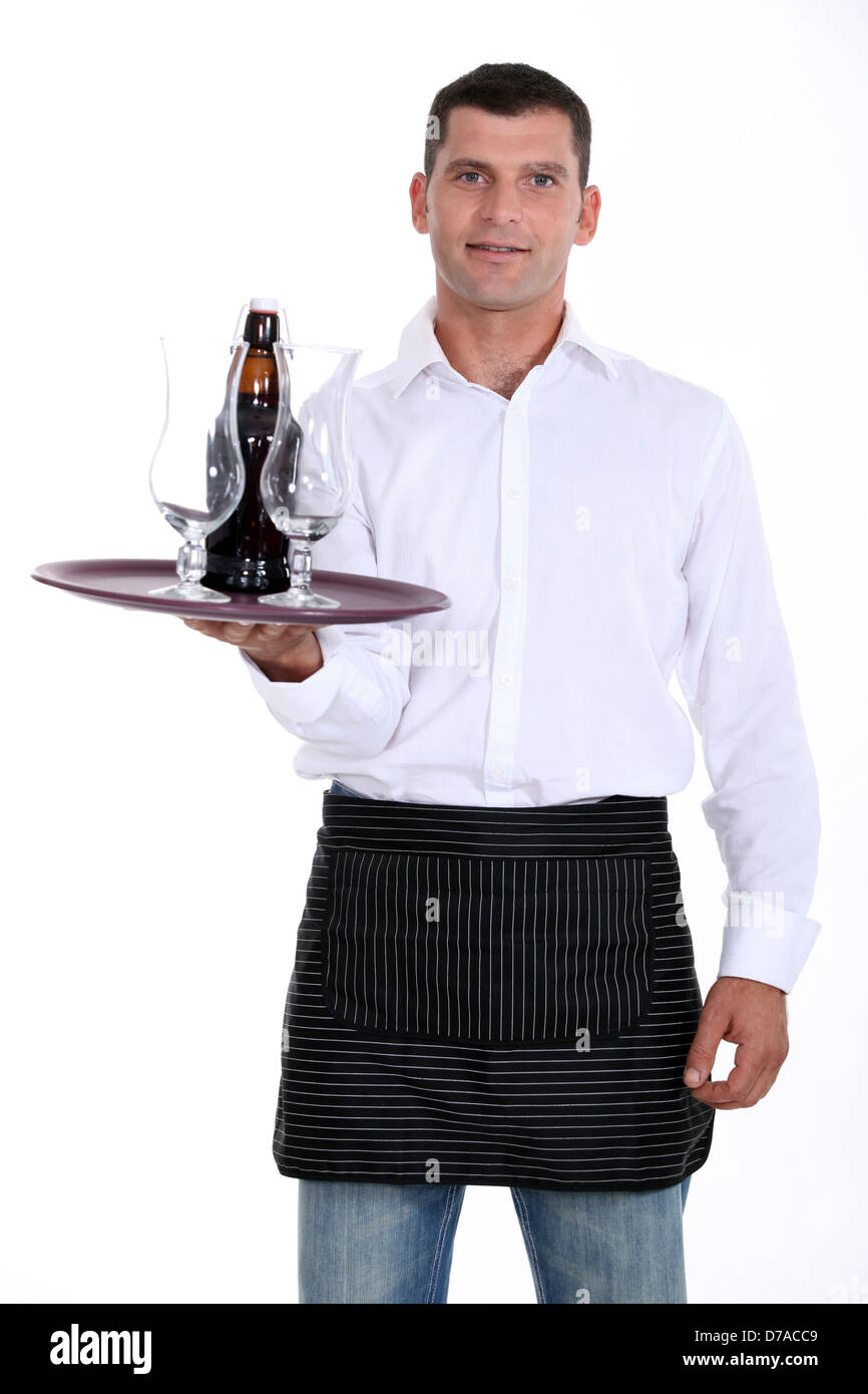 waiter holding tray with glasses and bottle Stock Photo - Alamy