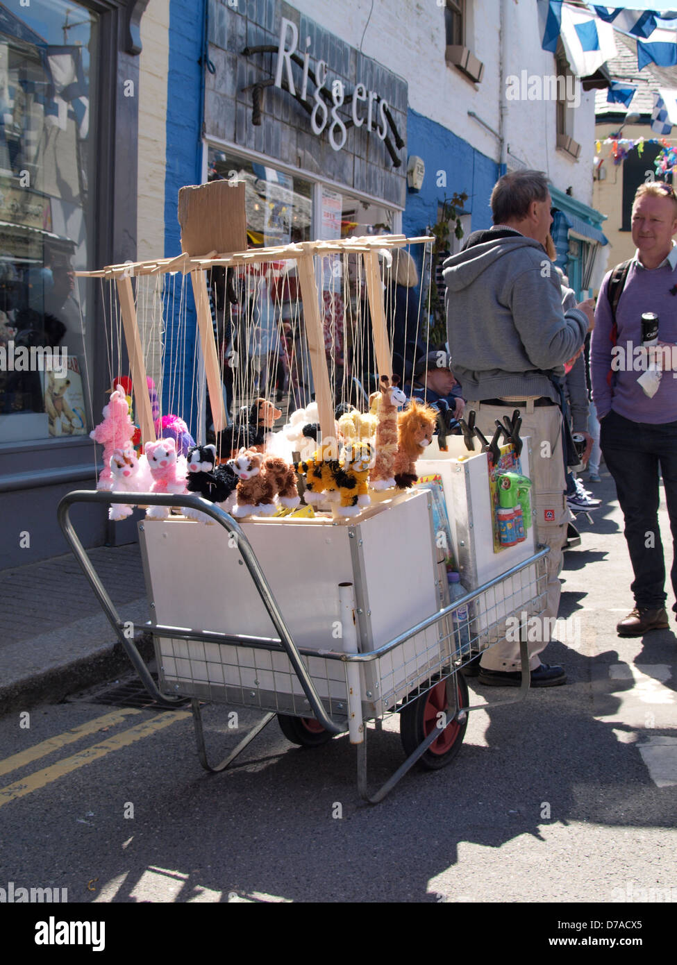 Street vendor selling puppets, Padstow, Cornwall, UK 2013 Stock Photo