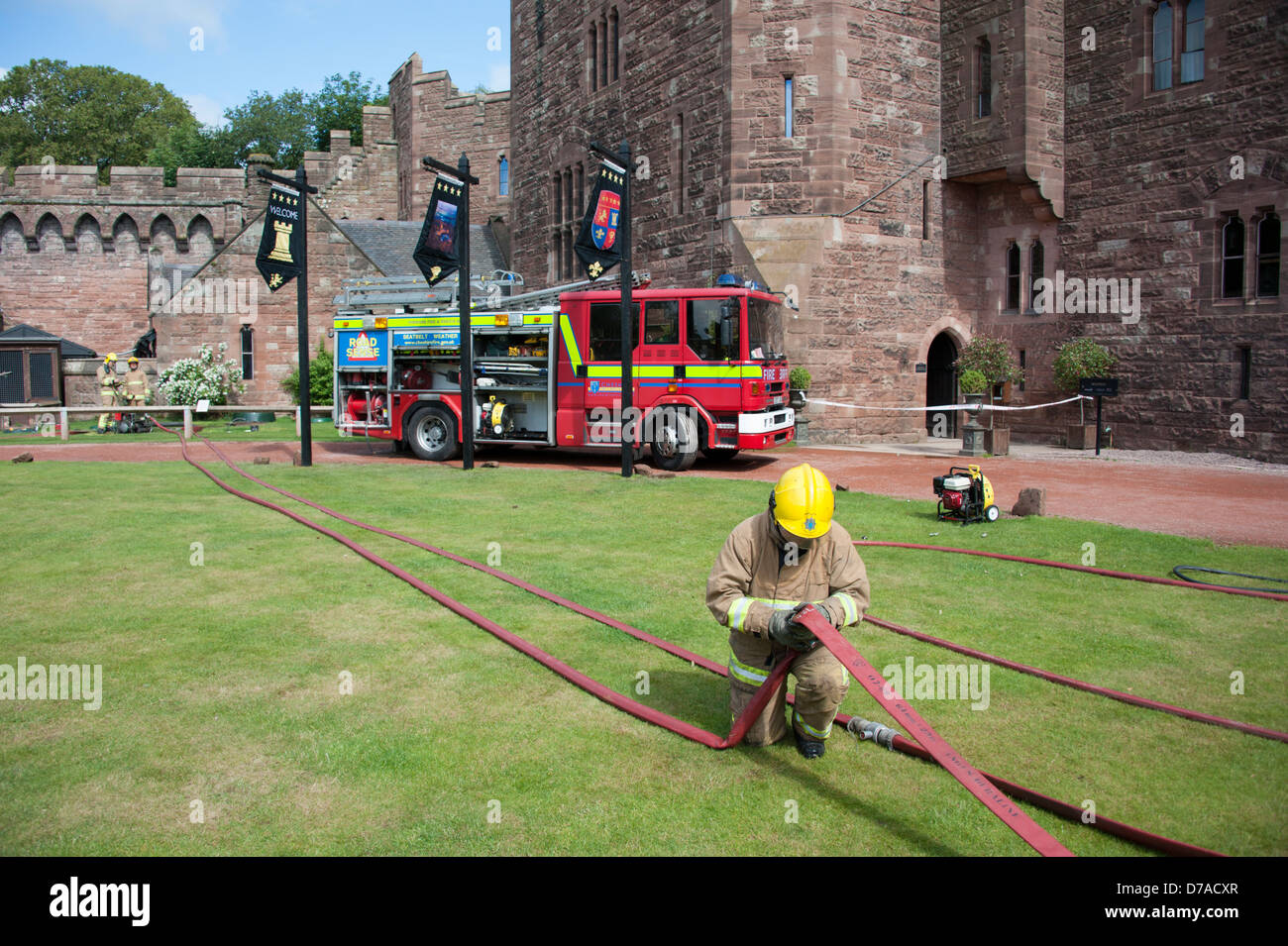 Fireman making up hose at Listed Building Castle Fire Stock Photo