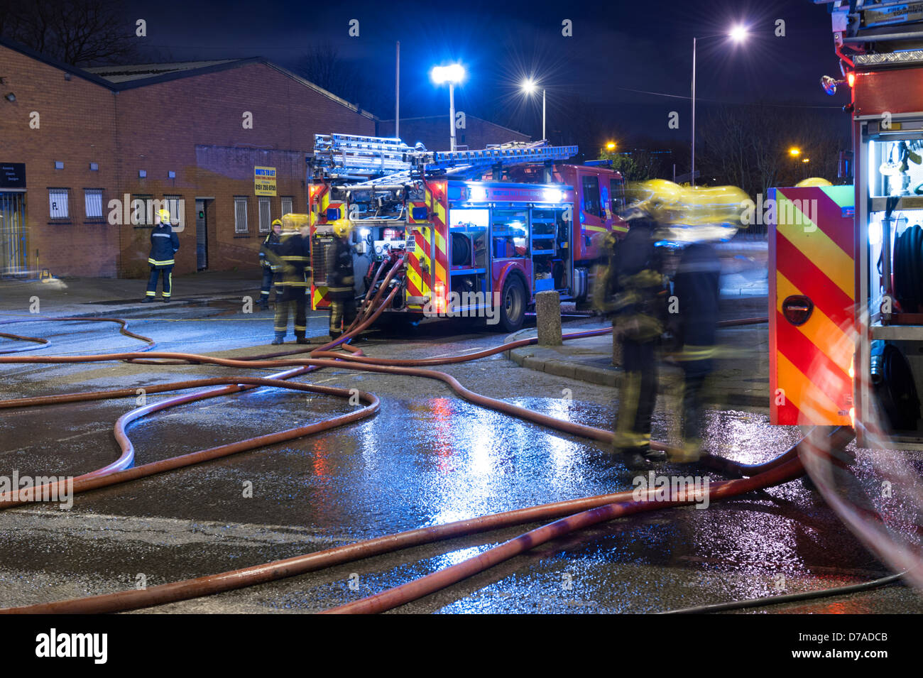 Fire Engines hose at Night Factory Fire Stock Photo