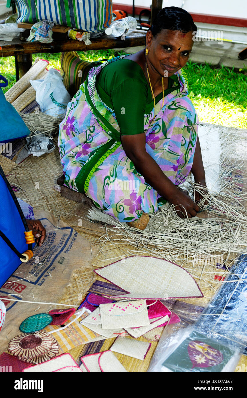 Indian woman weaving baskets at Coconut Lagoon resort, Kerala, India