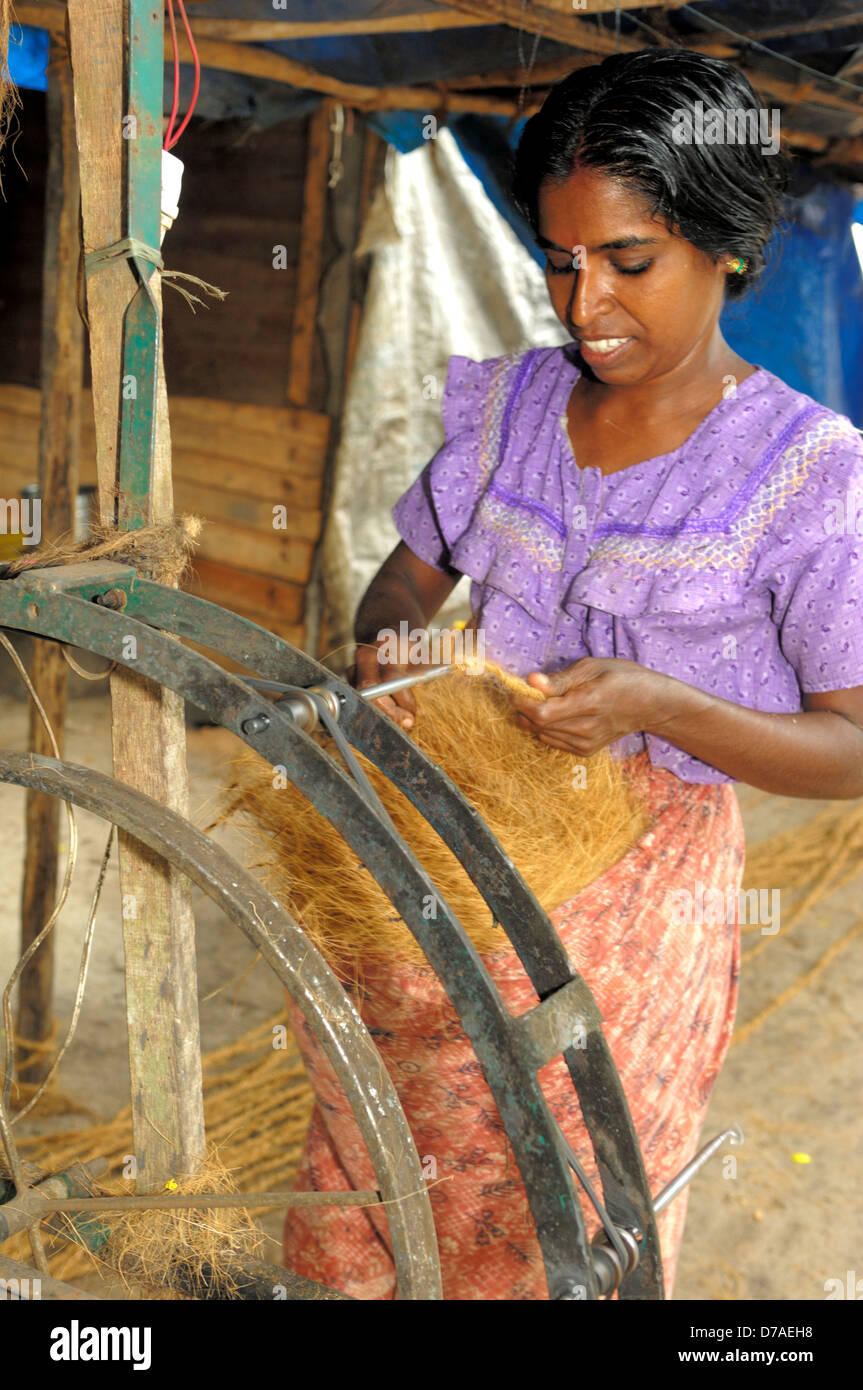 Indian woman spinning coconut fiber into twine in home coir cottage-industry, Kerala, India Stock Photo