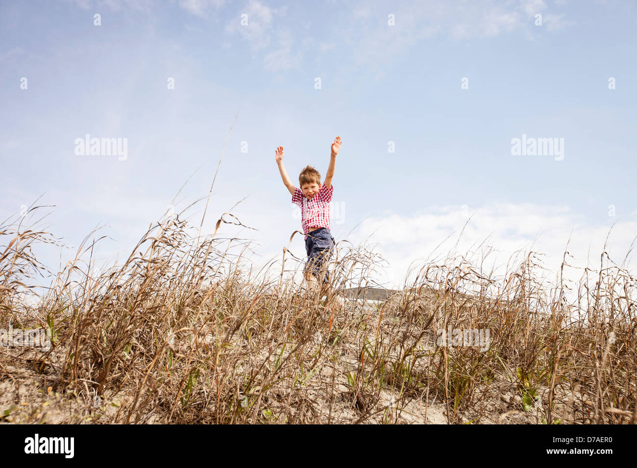 child running through dunes Stock Photo